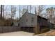Contemporary home featuring a three-car garage and unique wood siding at 3404 Vinings North Se Trl, Smyrna, GA 30080
