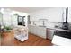 Bright kitchen features stainless steel appliances, white cabinets and countertops, and hardwood floors at 3404 Vinings North Se Trl, Smyrna, GA 30080