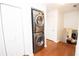 Upstairs laundry area featuring a stacked washer and dryer near storage and additional closet space at 3404 Vinings North Se Trl, Smyrna, GA 30080