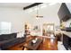Sun-filled living room boasts high ceilings, hardwood floors, modern furniture, and seamless flow to dining area at 3404 Vinings North Se Trl, Smyrna, GA 30080
