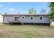 View of a backyard featuring a wooden deck and steps from the rear of the house at 6801 Red Maple Dr, Rex, GA 30273