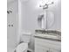Bathroom with granite vanity, a round mirror, and tiled shower and tub at 6801 Red Maple Dr, Rex, GA 30273