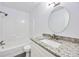 Clean bathroom featuring speckled vanity countertops, updated lighting, and a shower-tub combo at 6801 Red Maple Dr, Rex, GA 30273