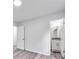 Bright bedroom with wood-look floors leading to a bathroom and a closet at 6801 Red Maple Dr, Rex, GA 30273