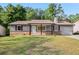 Charming single story home featuring brick accents, a well-manicured lawn, and inviting curb appeal at 6801 Red Maple Dr, Rex, GA 30273