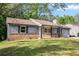Charming single story home featuring brick accents, a well-manicured lawn, and inviting curb appeal at 6801 Red Maple Dr, Rex, GA 30273