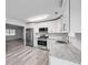 Modern kitchen featuring stainless steel appliances, white cabinets, and speckled countertops at 6801 Red Maple Dr, Rex, GA 30273
