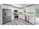 Modern kitchen featuring stainless steel appliances and white cabinets at 6801 Red Maple Dr, Rex, GA 30273