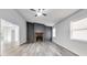 Bright living room features a stone fireplace and modern gray flooring at 6801 Red Maple Dr, Rex, GA 30273