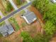 Overhead view of a landscaped yard featuring a stone retaining wall adjacent to a lush green wooded area at 8230 Dawson View Way, Cumming, GA 30028