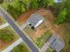 Aerial view featuring a home with a pristine lawn, landscaping, and a backyard stone retaining wall at 8230 Dawson View Way, Cumming, GA 30028