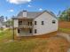 Exterior shot showing the backyard with the back of the house including a deck and a retaining wall at 8230 Dawson View Way, Cumming, GA 30028