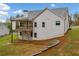 Exterior shot showing the backyard with the back of the house including a deck and a retaining wall at 8230 Dawson View Way, Cumming, GA 30028