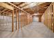 Unfinished basement featuring exposed beams, cement flooring, and insulated walls at 8230 Dawson View Way, Cumming, GA 30028