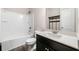 Cozy bathroom featuring a tub with shower, white toilet, vanity with a marble countertop, and dark wood cabinets at 8230 Dawson View Way, Cumming, GA 30028
