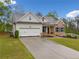 Charming single-Gathering home with a two-car garage, brick accents, and a well-manicured lawn at 8230 Dawson View Way, Cumming, GA 30028