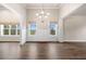 Living room featuring modern lighting, neutral paint, hardwood floors, and natural light from several windows at 8230 Dawson View Way, Cumming, GA 30028