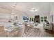 Open-concept living and dining area with fireplace and backyard views at 8230 Dawson View Way, Cumming, GA 30028