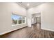 Living room featuring neutral paint, hardwood floors, and natural light from a window at 8230 Dawson View Way, Cumming, GA 30028