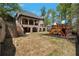 Expansive backyard with a multi-level patio, a playground set, and ample space for outdoor activities at 140 Johnson Rd, Suwanee, GA 30024