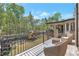 Enjoy the outdoors on this charming brick balcony with wicker chairs and a beautiful backyard view at 140 Johnson Rd, Suwanee, GA 30024