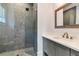 Contemporary bathroom with a glass-enclosed shower featuring decorative tile and gray vanity with a stone countertop at 140 Johnson Rd, Suwanee, GA 30024