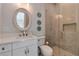 Bathroom featuring an oval mirror, glass shower, and mosaic tile at 140 Johnson Rd, Suwanee, GA 30024