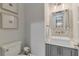 Modern half bathroom featuring a floating sink, stylish mirror, and elegant fixtures at 140 Johnson Rd, Suwanee, GA 30024