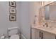 A vanity with a rectangular sink and a silver trimmed mirror sits next to the toilet in this bathroom at 140 Johnson Rd, Suwanee, GA 30024