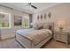 This primary bedroom has decorative wall mirrors, recessed lighting, and hardwood floors at 140 Johnson Rd, Suwanee, GA 30024