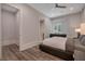Bright bedroom with hardwood floors, a modern bed frame, and a window overlooking the backyard at 140 Johnson Rd, Suwanee, GA 30024
