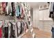 Spacious closet with ample storage, custom cabinets, ladder access, and wood flooring at 140 Johnson Rd, Suwanee, GA 30024