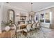 Elegant dining room showcasing a large wooden table, chandelier, and a large window with natural light at 140 Johnson Rd, Suwanee, GA 30024