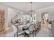 Open-concept dining room, seamlessly connected to a curved staircase and adjacent living spaces at 140 Johnson Rd, Suwanee, GA 30024