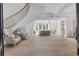 Grand foyer featuring a curved staircase, high ceilings, and abundant natural light at 140 Johnson Rd, Suwanee, GA 30024