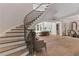 Grand foyer with a curved staircase, hardwood floors, and elegant decor at 140 Johnson Rd, Suwanee, GA 30024