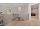 Hallway landing featuring an elegant chandelier, staircase, and view of a cozy living space at 140 Johnson Rd, Suwanee, GA 30024