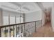 Hallway with coffered ceiling, window views, and iron railings at 140 Johnson Rd, Suwanee, GA 30024