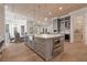 Open kitchen with large island, stainless steel appliances, and a dining area at 140 Johnson Rd, Suwanee, GA 30024