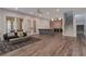 Spacious living room featuring neutral walls and furniture, and a wet bar area with a brick accent wall at 140 Johnson Rd, Suwanee, GA 30024
