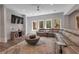 Spacious living room with hardwood floors, large windows, and a plush sectional sofa at 140 Johnson Rd, Suwanee, GA 30024