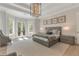 The main bedroom includes a chandelier, patterned carpet, and doors leading to the outside at 140 Johnson Rd, Suwanee, GA 30024