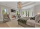 The main bedroom features a fireplace, recessed lights, bay windows, a chandelier, and two chairs at 140 Johnson Rd, Suwanee, GA 30024