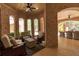 Inviting outdoor living space featuring brick arches, ceiling fans, and comfortable seating for relaxation and entertaining at 140 Johnson Rd, Suwanee, GA 30024