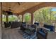 Covered brick patio with comfortable seating and a ceiling fan for outdoor enjoyment at 140 Johnson Rd, Suwanee, GA 30024