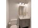 Neat powder room with a modern vanity, framed mirror, and light fixture at 140 Johnson Rd, Suwanee, GA 30024