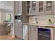 Elegant wet bar area with a sink, wine cooler, and built-in coffee maker at 140 Johnson Rd, Suwanee, GA 30024