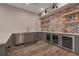 Wet bar featuring stainless steel appliances, wooden shelving, a brick wall, and gray cabinets at 140 Johnson Rd, Suwanee, GA 30024