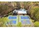 Aerial view of community featuring tennis courts, a gazebo, and an outdoor pool surrounded by lush trees at 180 Spring Ridge Trace, Roswell, GA 30076