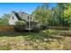 A spacious backyard featuring a well-maintained lawn, wooden fence, and screened-in porch perfect for relaxation and outdoor activities at 180 Spring Ridge Trace, Roswell, GA 30076